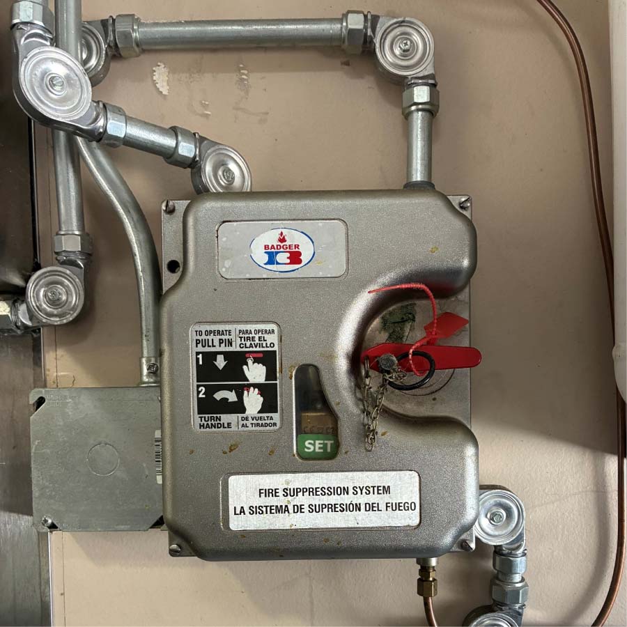 badger-fire-supression Badger manual pull station and piping for a wall-mounted fire suppression system control unit
