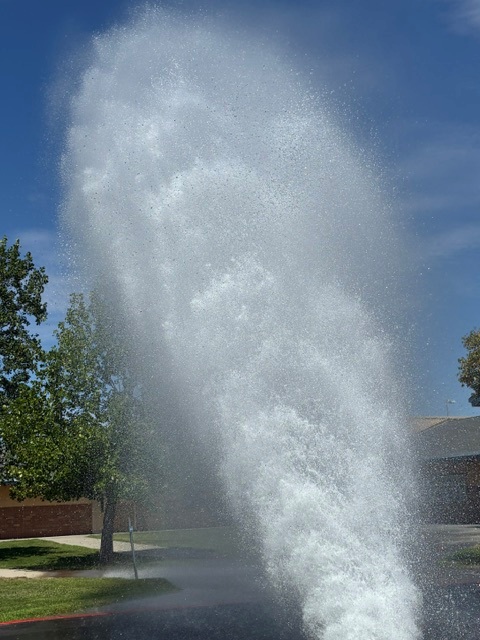 fire hydrant testing Fire hydrant flow test showing high-pressure water discharge during a residential/commercial hydrant inspection